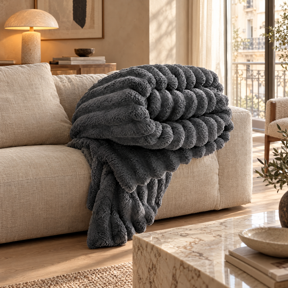 Homeware - Dark Grey Ribbed Faux Lambswool Throw draped over a sofa