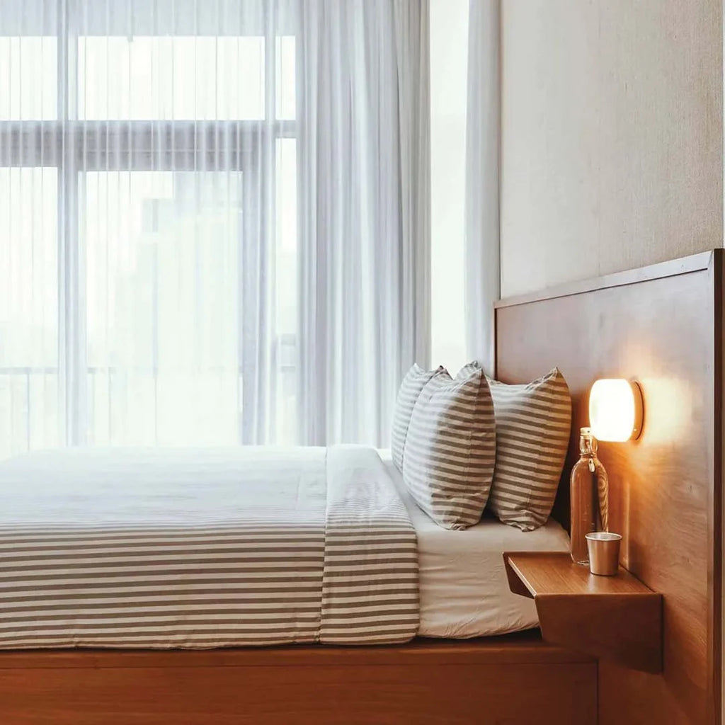 Compact Curved Wall Light - Beside Bed on Wooden Headboard