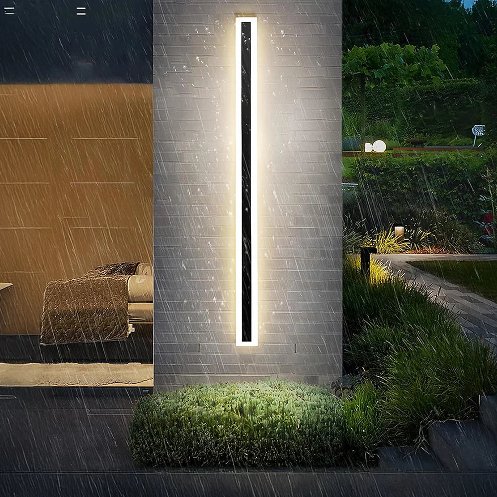 Slim Rectangular Outdoor Wall Light - Lit on Pillar in the Rain