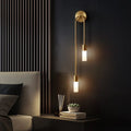 Linear Gold LED Wall Sconce - Lit Beside Bed on Dark Wall