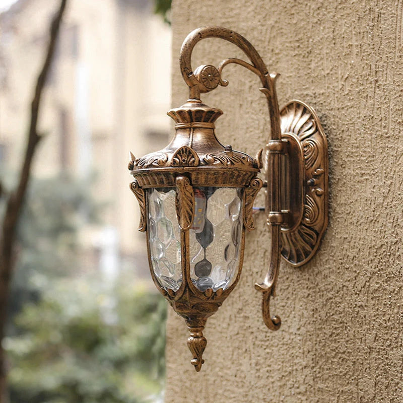 Vintage Outdoor Wall Lantern with Scroll Arm - Bronze Finish on Render Wall
