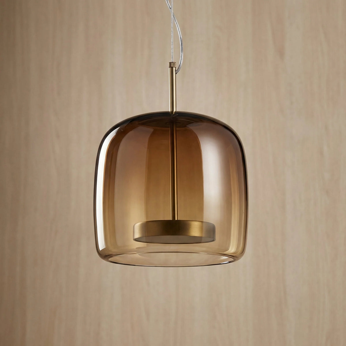 Tinted Glass Pendant Light - Dark Amber Rounded Shade Against Wood Panelling
