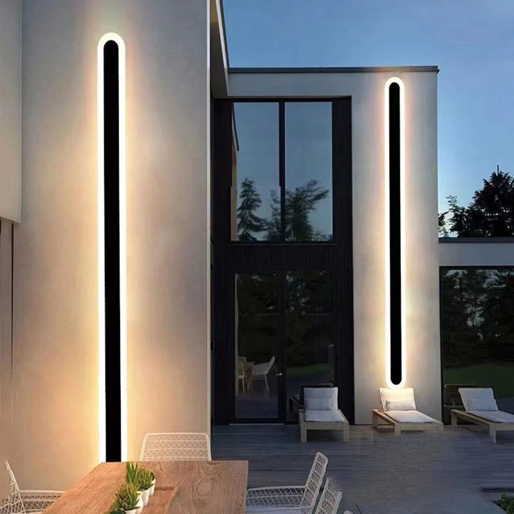 Black Linear Outdoor Wall Light - Pair on Exterior Walls at Dusk