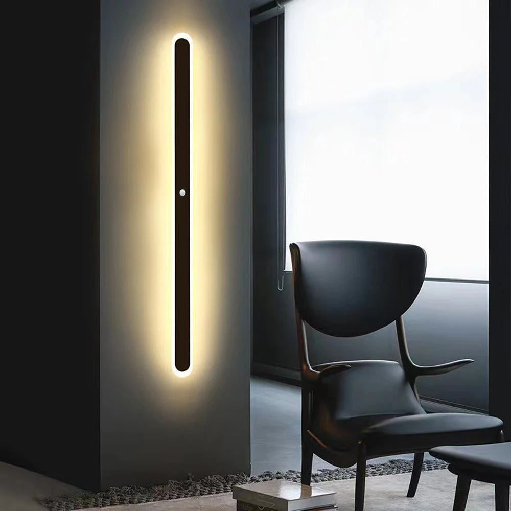 Black Linear Outdoor Wall Light - Sensor Version Beside Armchair