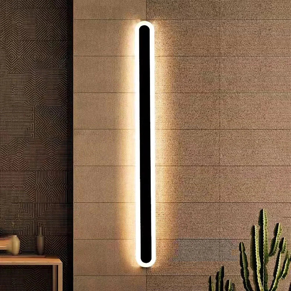 Black Linear Outdoor Wall Light - Lit on Textured Wall