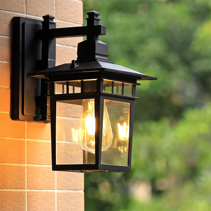 Clear Glass Outdoor Wall Lantern - Black Finish Lit on Tiled Wall