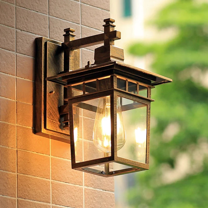 Clear Glass Outdoor Wall Lantern - Dark Finish Lit on Tiled Wall, Side Angle