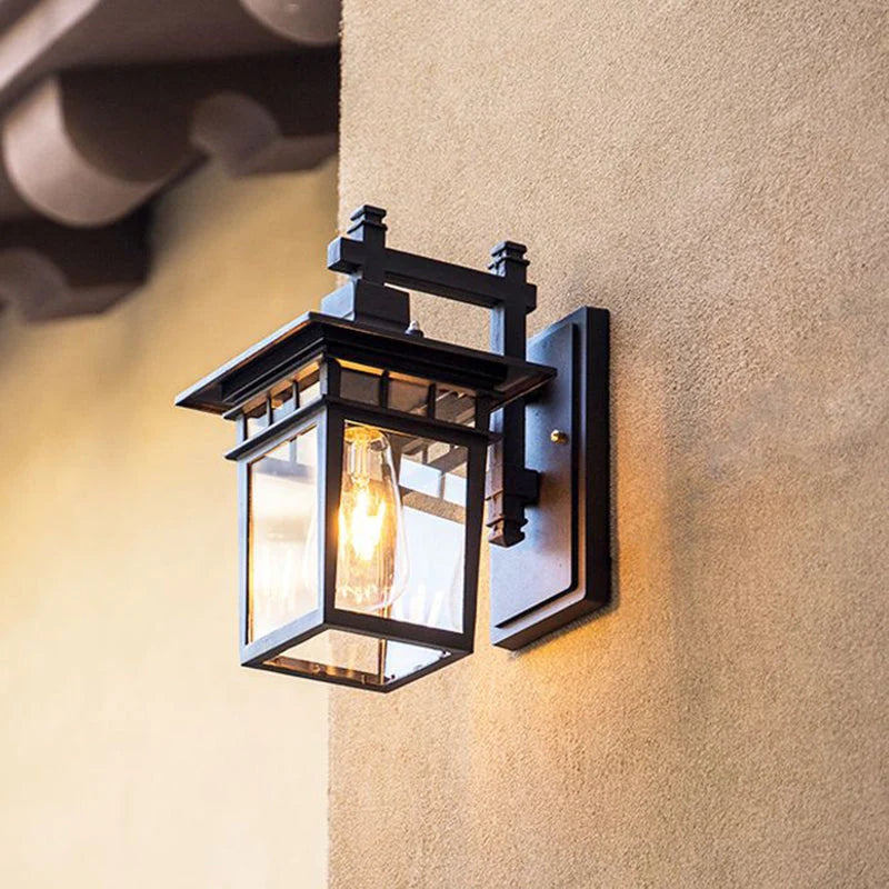 Clear Glass Outdoor Wall Lantern - Black Finish, Side View on Render Wall