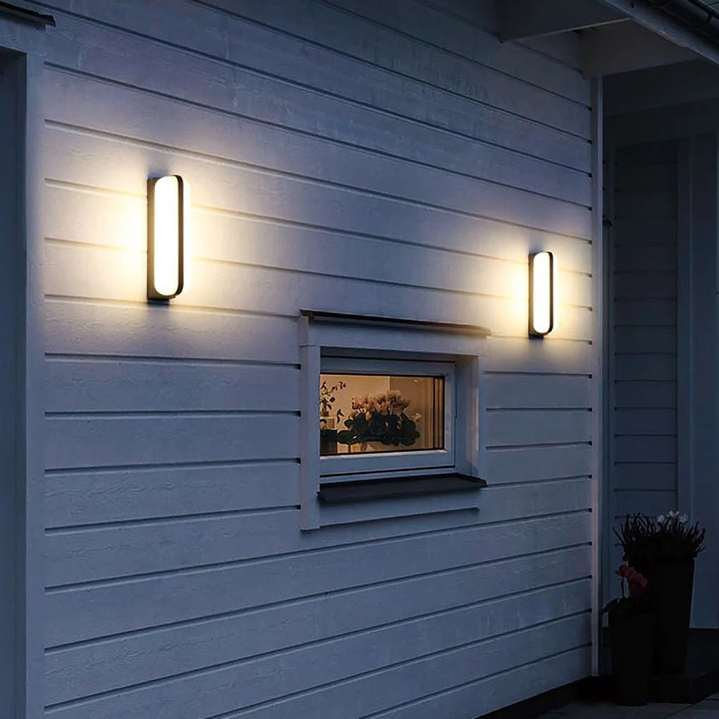 Modern Outdoor LED Wall Light - Pair Mounted Vertically on Cladding at Night