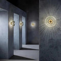 Ribbed Glass Disc Wall Sconce - Smoke Grey Glass Lit on Concrete Wall