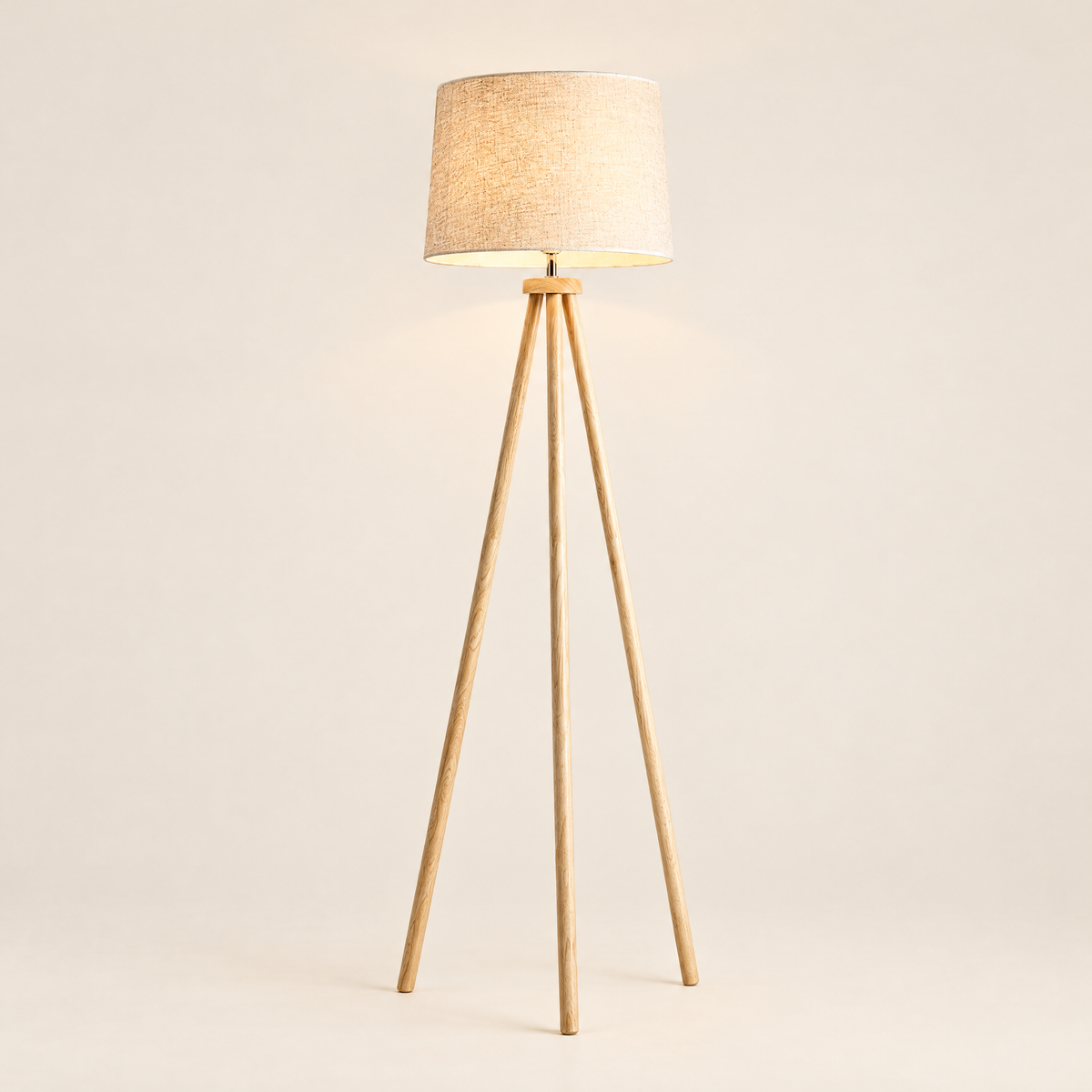 Wooden Tripod Floor Lamp with Linen Drum Shade - Lit on Cream Background