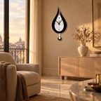 Teardrop Pendulum Wall Clock - Black Finish in Living Room at Sunset
