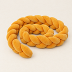 Braided Cot Bumper - Ochre Yellow Coiled on Off-White Background
