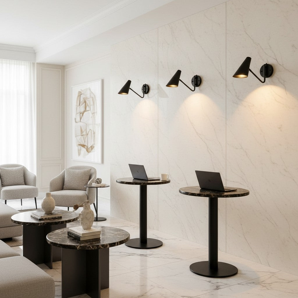 Lorvali adjustable black iron swing arm wall sconces mounted on a marble wall in a modern minimalist interior