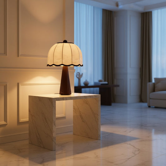Lorvali Beatrice table lamp with a ribbed walnut ash wood base and scalloped cream fabric shade on a marble console.