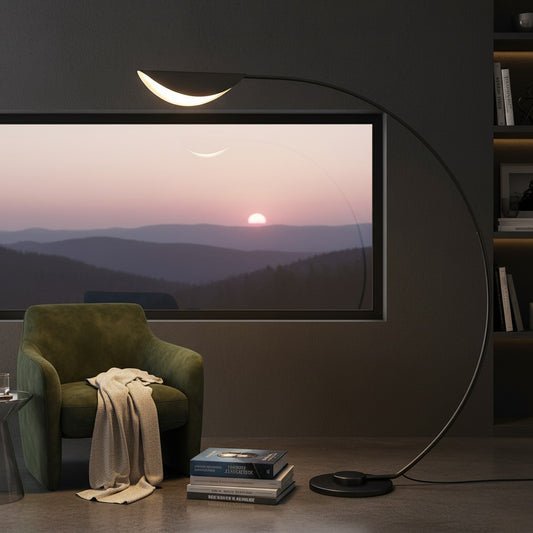 Lorvali contemporary black arc floor lamp with a white acrylic shade in a cozy reading corner with a green armchair.