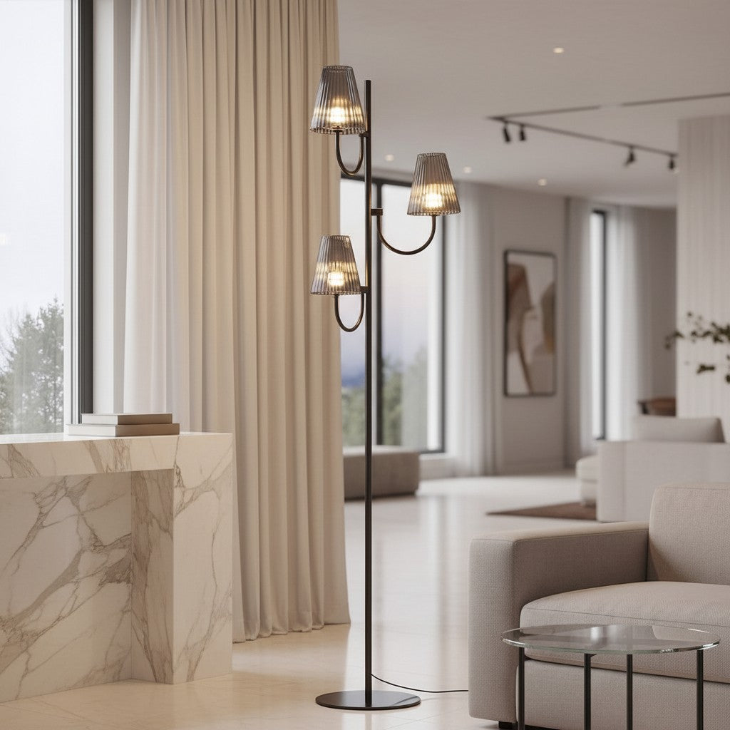 Lorvali contemporary floor lamp with a black aluminum body and three gray smoke glass shades in a modern living room.