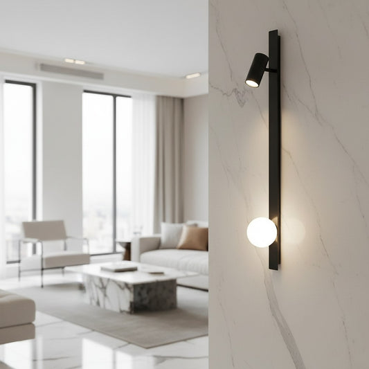 Lorvali modern black and gold linear wall lamp with an adjustable spotlight and glowing orb light on a marble wall.