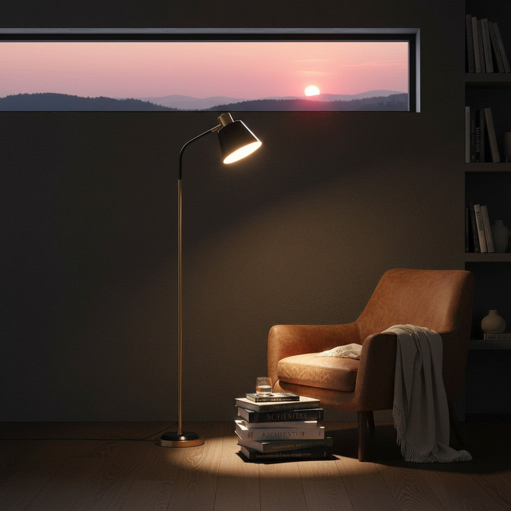Lorvali 62-inch black and gold metal floor lamp with adjustable cone shade casting a warm glow next to a leather chair