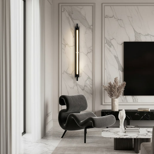 Lorvali minimalist black linear LED wall strip light with transparent glass shade mounted on a marble wall in a lounge