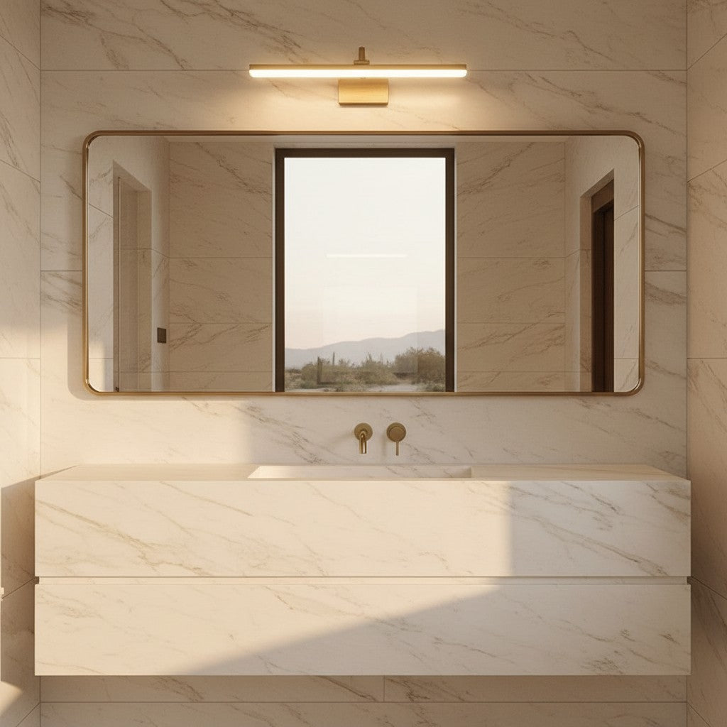 Lorvali modern brass LED vanity light bar mounted above a rectangular mirror in a marble bathroom.