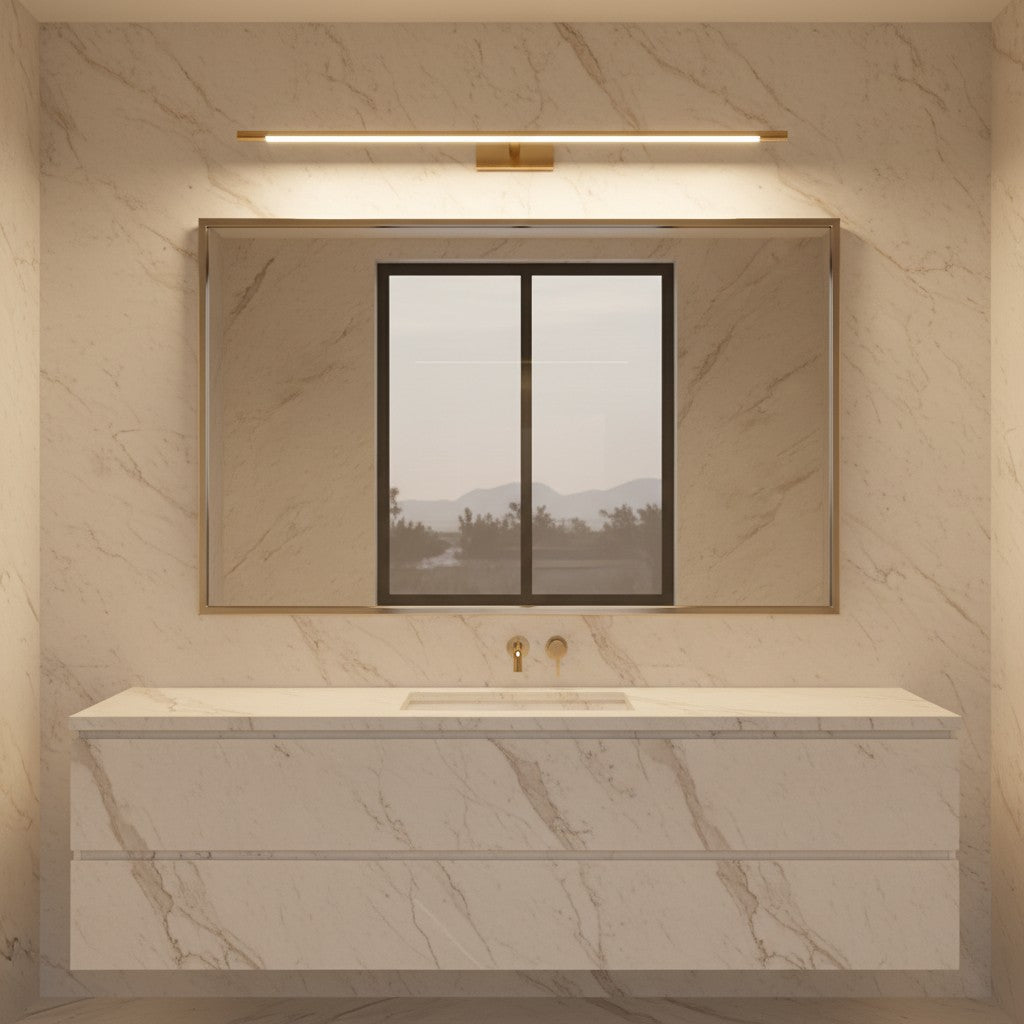 Lorvali brass linear LED vanity light mounted above a rectangular mirror in a modern marble bathroom