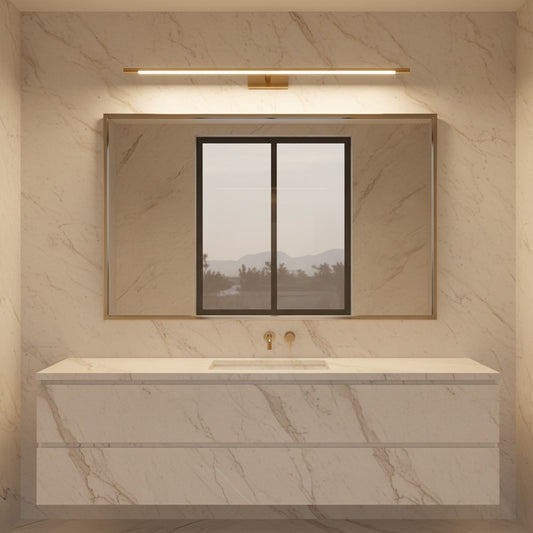 Lorvali brass linear LED vanity light mounted above a rectangular mirror in a modern marble bathroom