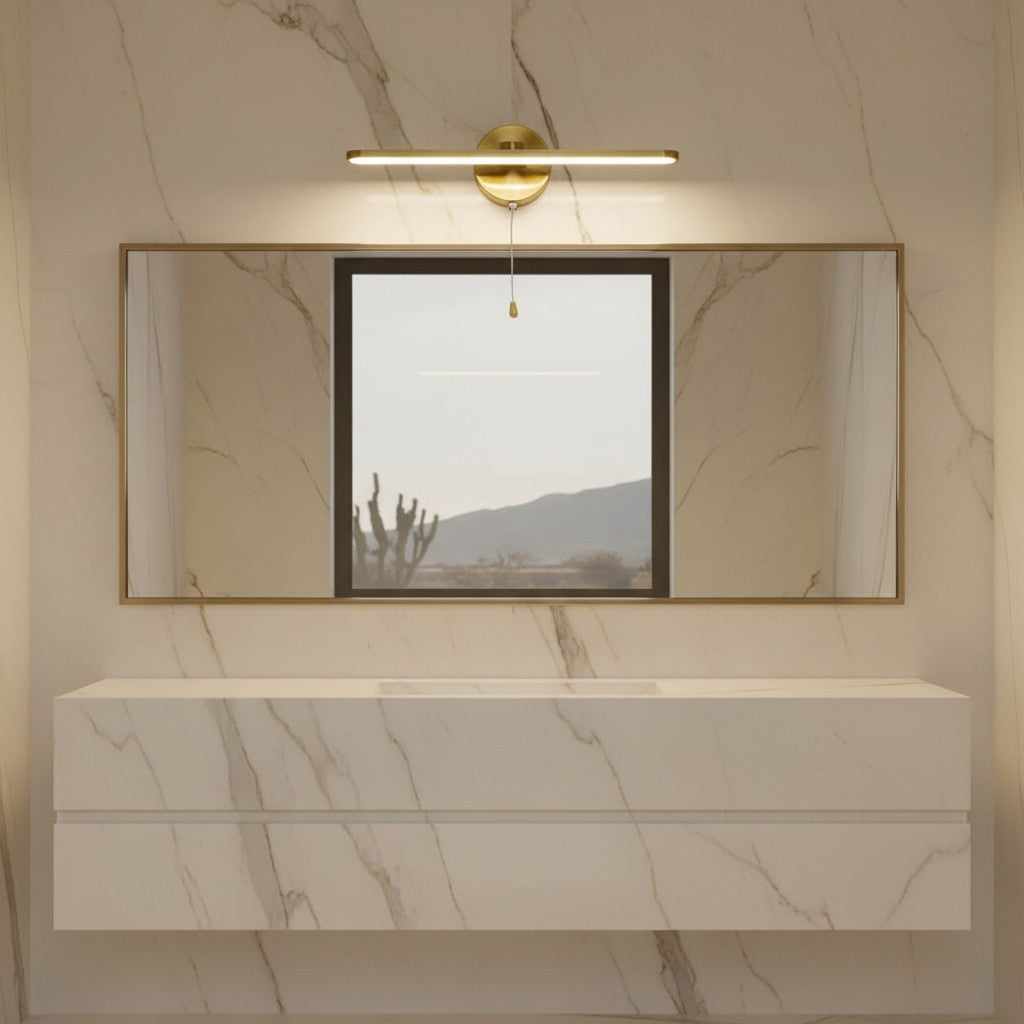 Lorvali modern linear LED vanity light in yellow bronze with a pull rope switch mounted above a bathroom mirror.