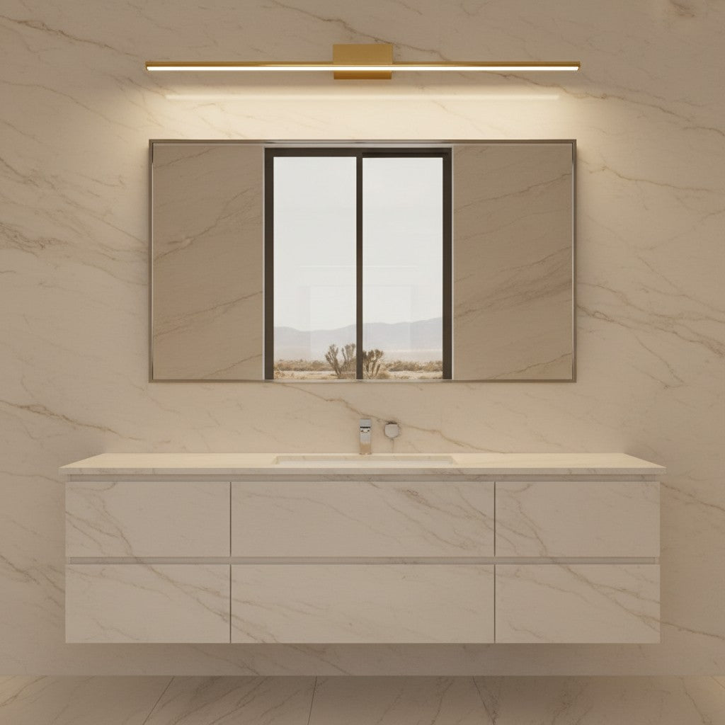 Lorvali brushed brass linear LED vanity light mounted above a bathroom mirror with a modern marble vanity cabinet.