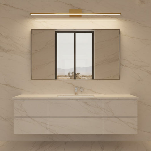 Lorvali brushed brass linear LED vanity light mounted above a bathroom mirror with a modern marble vanity cabinet.