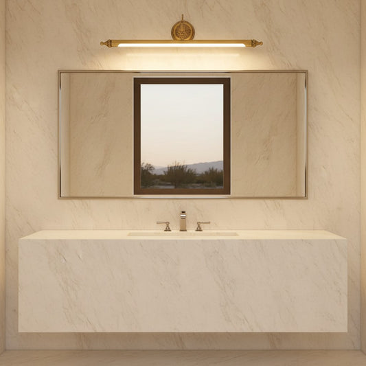 Lorvali brushed gold linear vanity light bar mounted above a bathroom mirror with a marble countertop and sink.