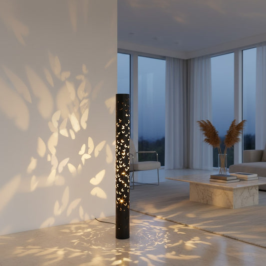 Lorvali modern black cylindrical floor lamp projecting dreamy butterfly shadows on a white wall in a living room