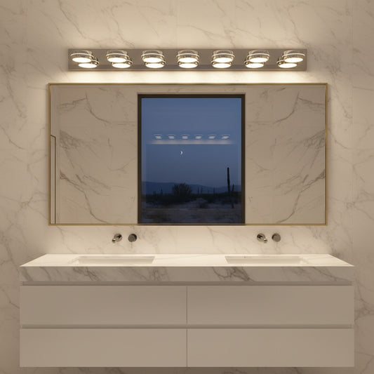 Lorvali chrome bathroom vanity light with six LED heads mounted above a large mirror on a marble wall.