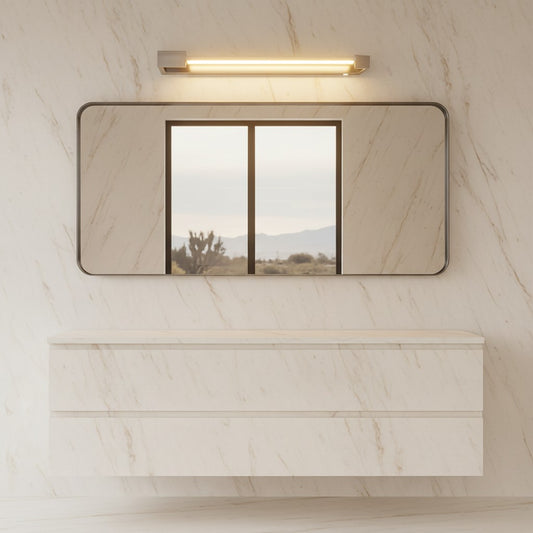 Lorvali modern chrome vanity light mounted above a rectangular mirror on a marble wall in a contemporary bathroom