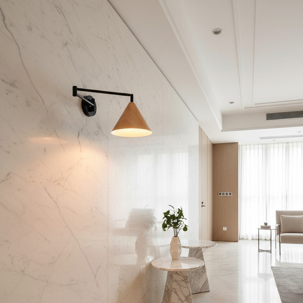 Lorvali mid-century cone swing arm wall sconce with wood grain finish mounted on a white marble wall in a modern room.