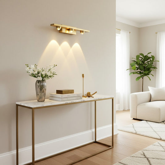 Lorvali copper LED wall washer light with three glass shades mounted above a marble console table in a modern living room