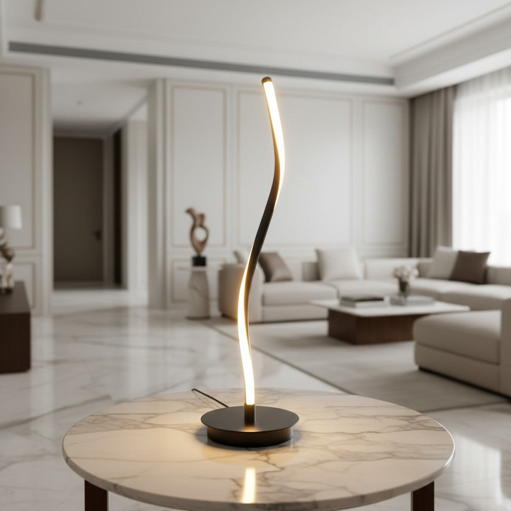 Lorvali contemporary LED table lamp with a sleek black curved iron design and integrated light on a marble table.