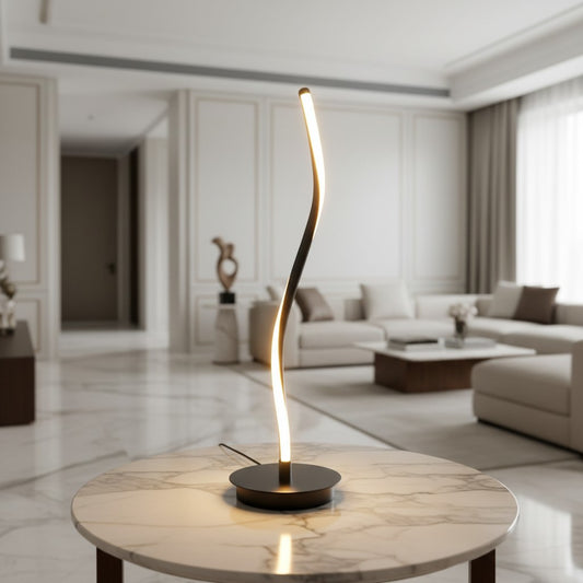 Lorvali contemporary LED table lamp with a sleek black curved iron design and integrated light on a marble table.