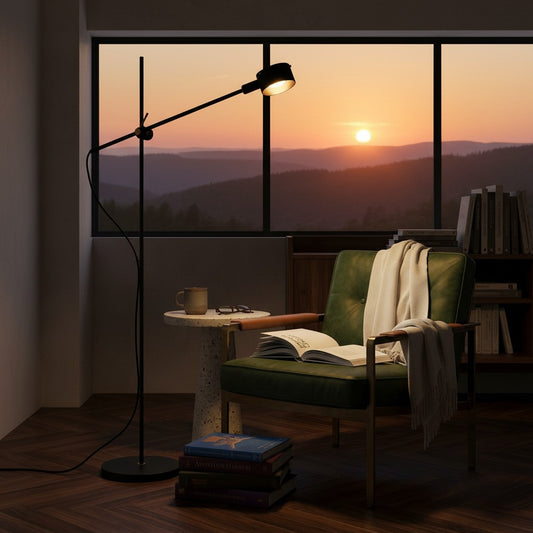 Lorvali Dessaul adjustable black metal floor lamp in a cozy reading nook with a green armchair at sunset.