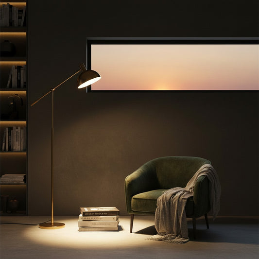Lorvali Devon floor lamp in gold metal with a modern rocker arm design, illuminating a cozy living room corner.