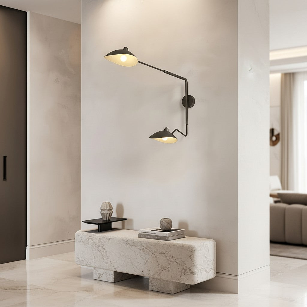 Lorvali double-head black iron swing arm wall light with 360-degree adjustable heads mounted on a modern interior wall.