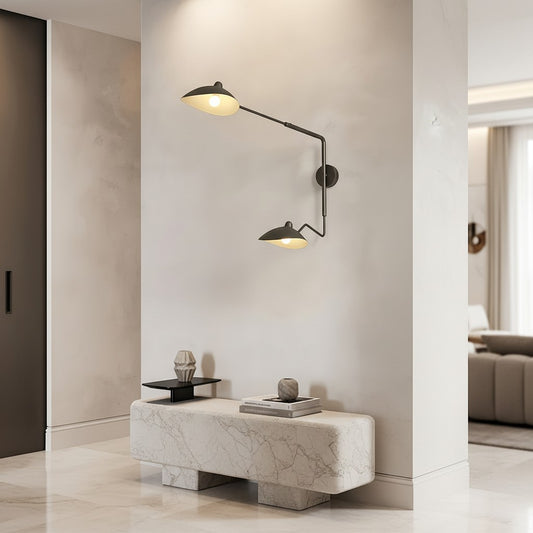 Lorvali double-head black iron swing arm wall light with 360-degree adjustable heads mounted on a modern interior wall.