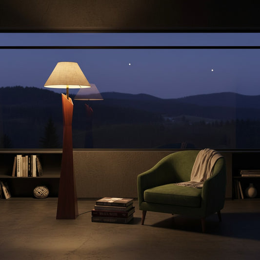 Lorvali Fenno floor lamp with a walnut-colored resin base and fabric shade, placed in a cozy room at night.