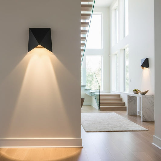 Lorvali modern geometric black aluminum LED wall sconce casting warm light on a white interior wall