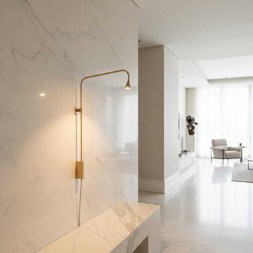 Lorvali minimalist gold iron swing arm wall lamp mounted on a white marble wall in a modern living room