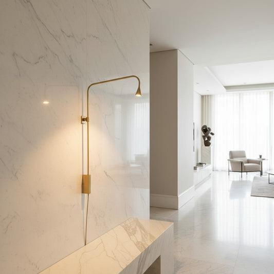 Lorvali minimalist gold iron swing arm wall lamp mounted on a white marble wall in a modern living room