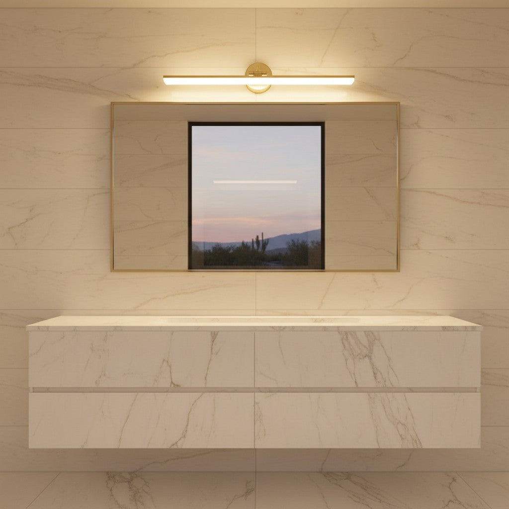 Lorvali gold LED bathroom vanity light mounted above a rectangular mirror on a marble wall in a modern bathroom.