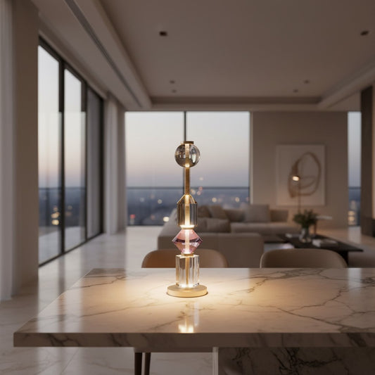 Lorvali Gusto table lamp with purple and amber glass geometric shapes and a copper base on a marble table.