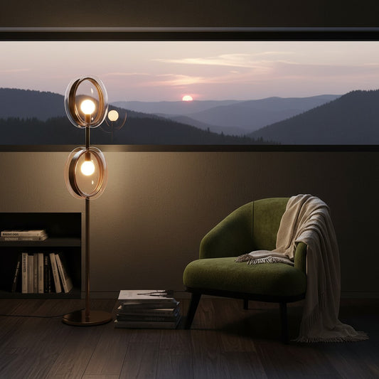 Lorvali Hailie floor lamp with blown glass lenses and gold finish, placed in a cozy room with a sunset mountain view.