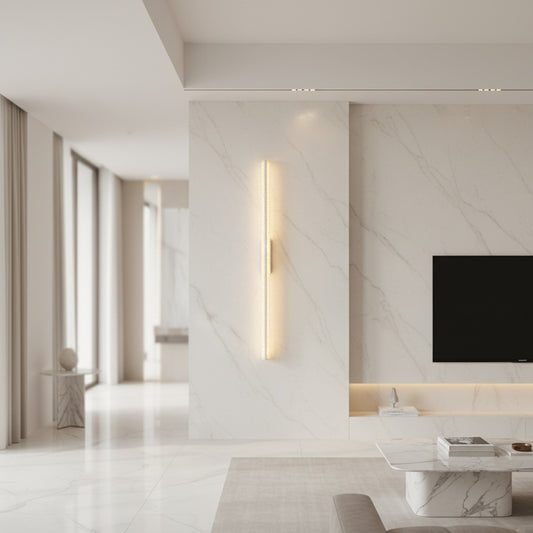 Lorvali 41-inch linear LED wall sconce with crystal-like acrylic shade mounted vertically on a white marble wall.